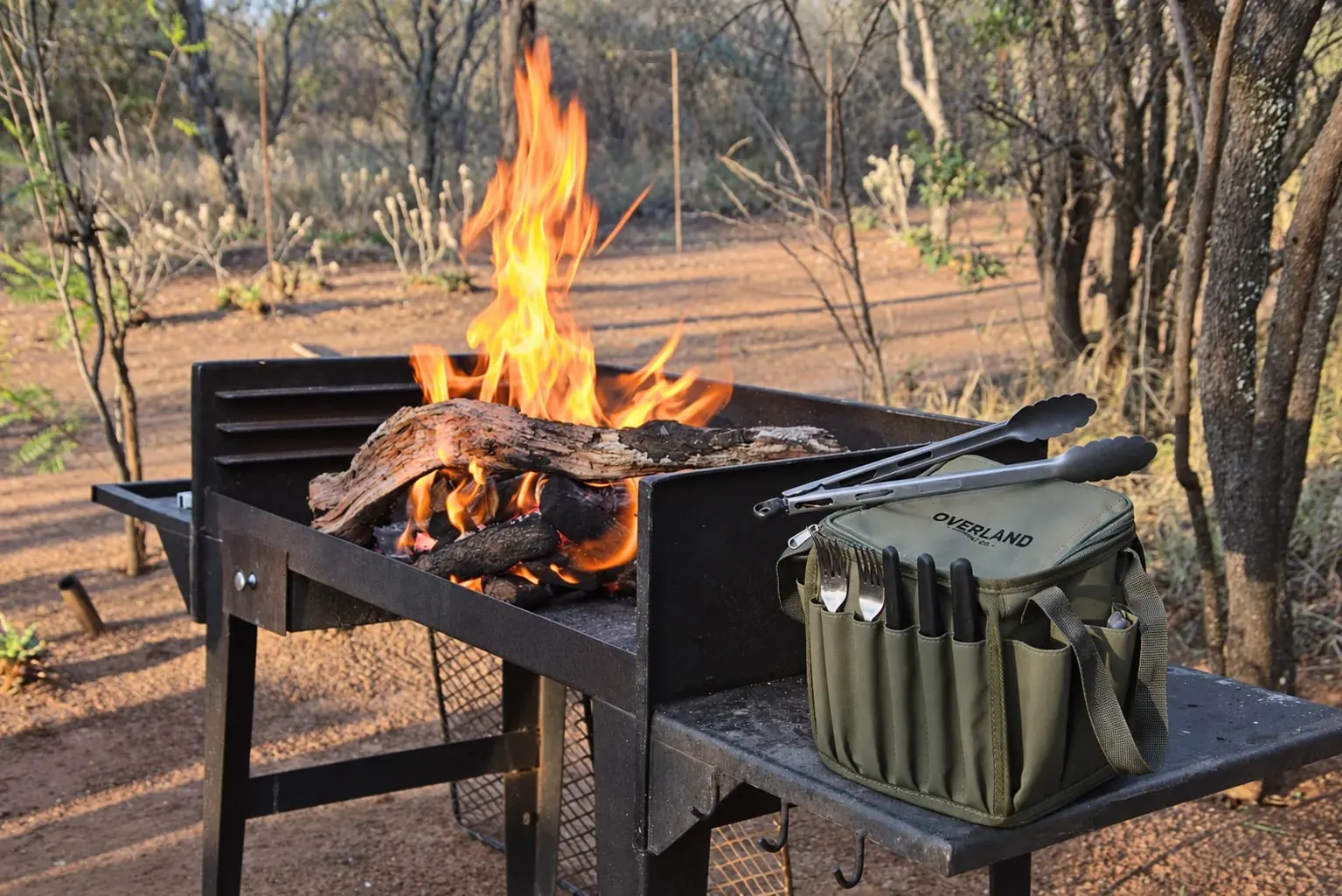 The Alles Sakkie beside a fire at a bush braai stand